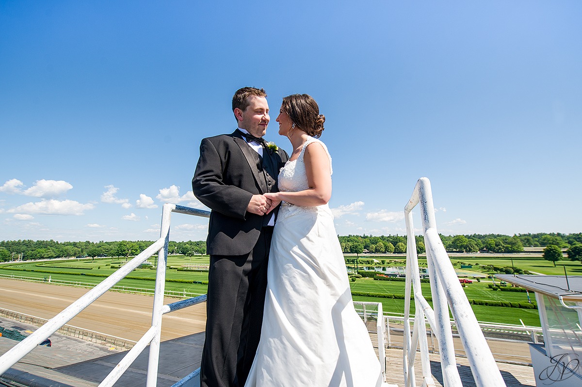 photo of bride and groom with view of saratoga race track