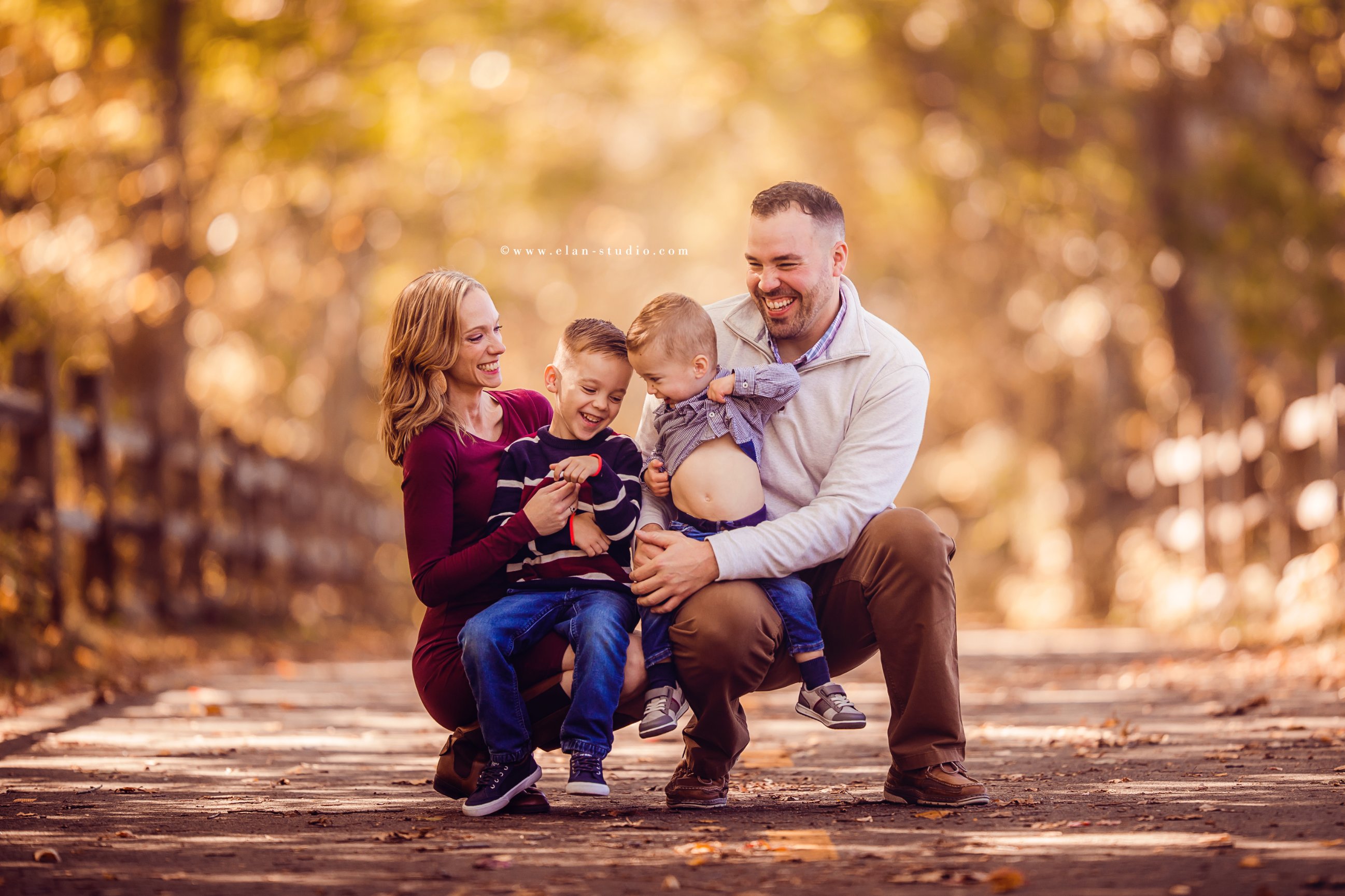 tickle pose fall family portrait with two young boys