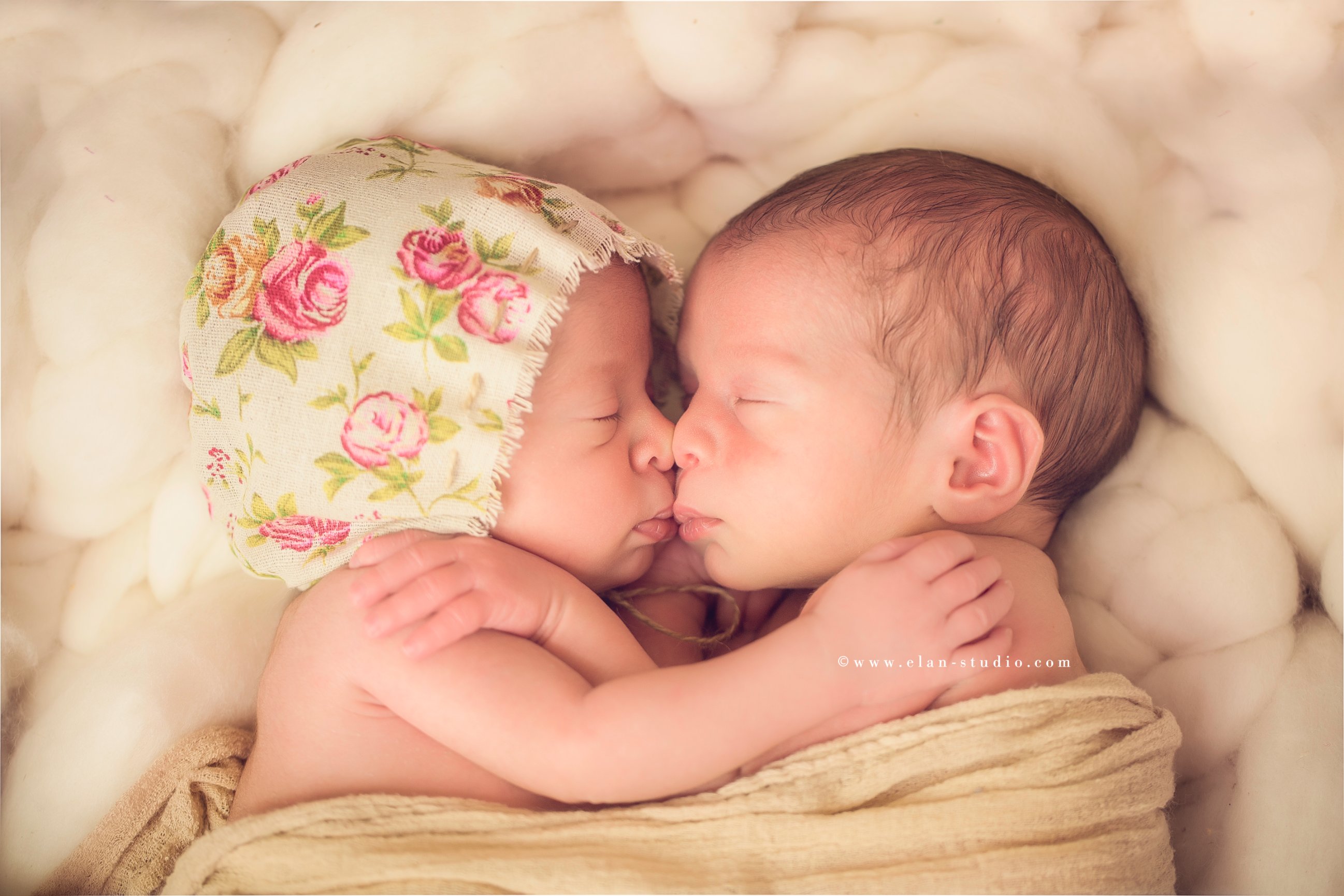 newborn twins hugging