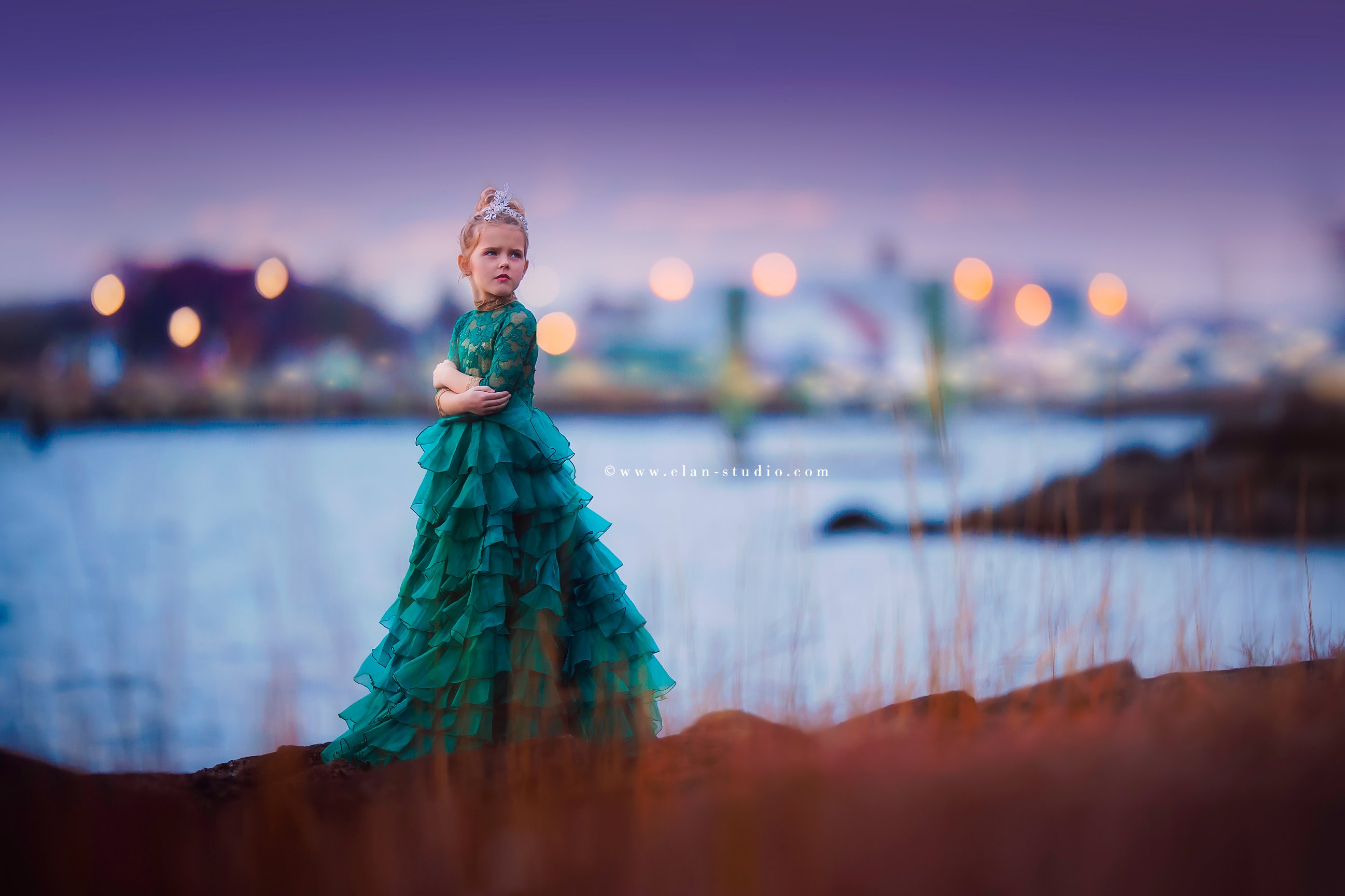 little girl in festive green dress at dusk