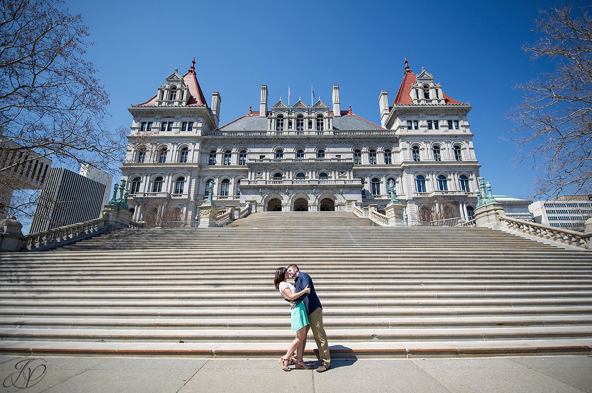 young couple kissing on stairs, couple sharing a moment on stairs of capital building, capital building albany engagement photos, albany engagement photographers, engagement session in capital building albany