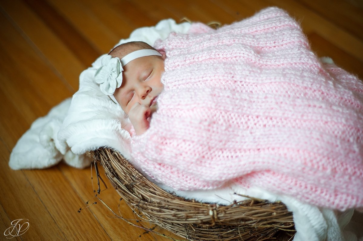 vintage photo of newborn sleeping in basket