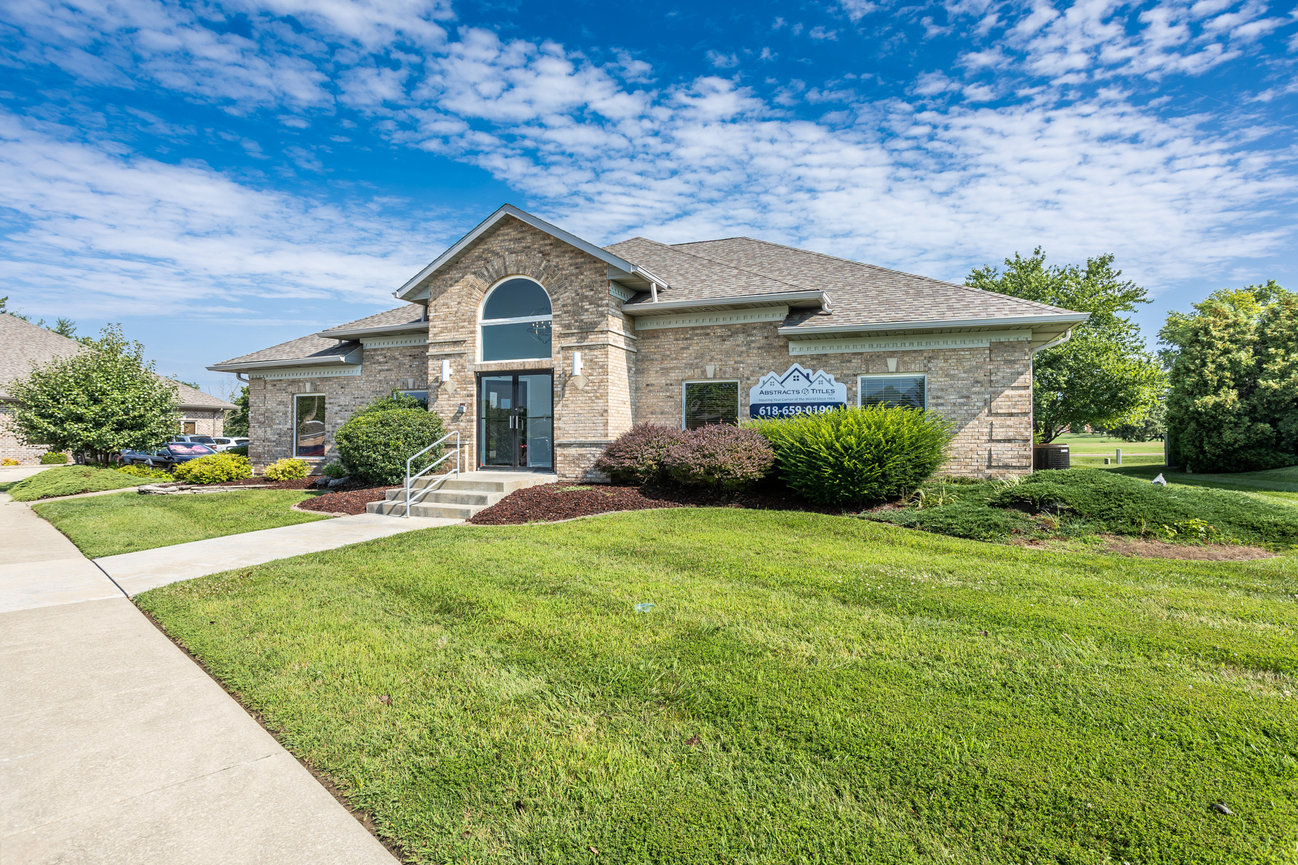 Brick house with large front lawn