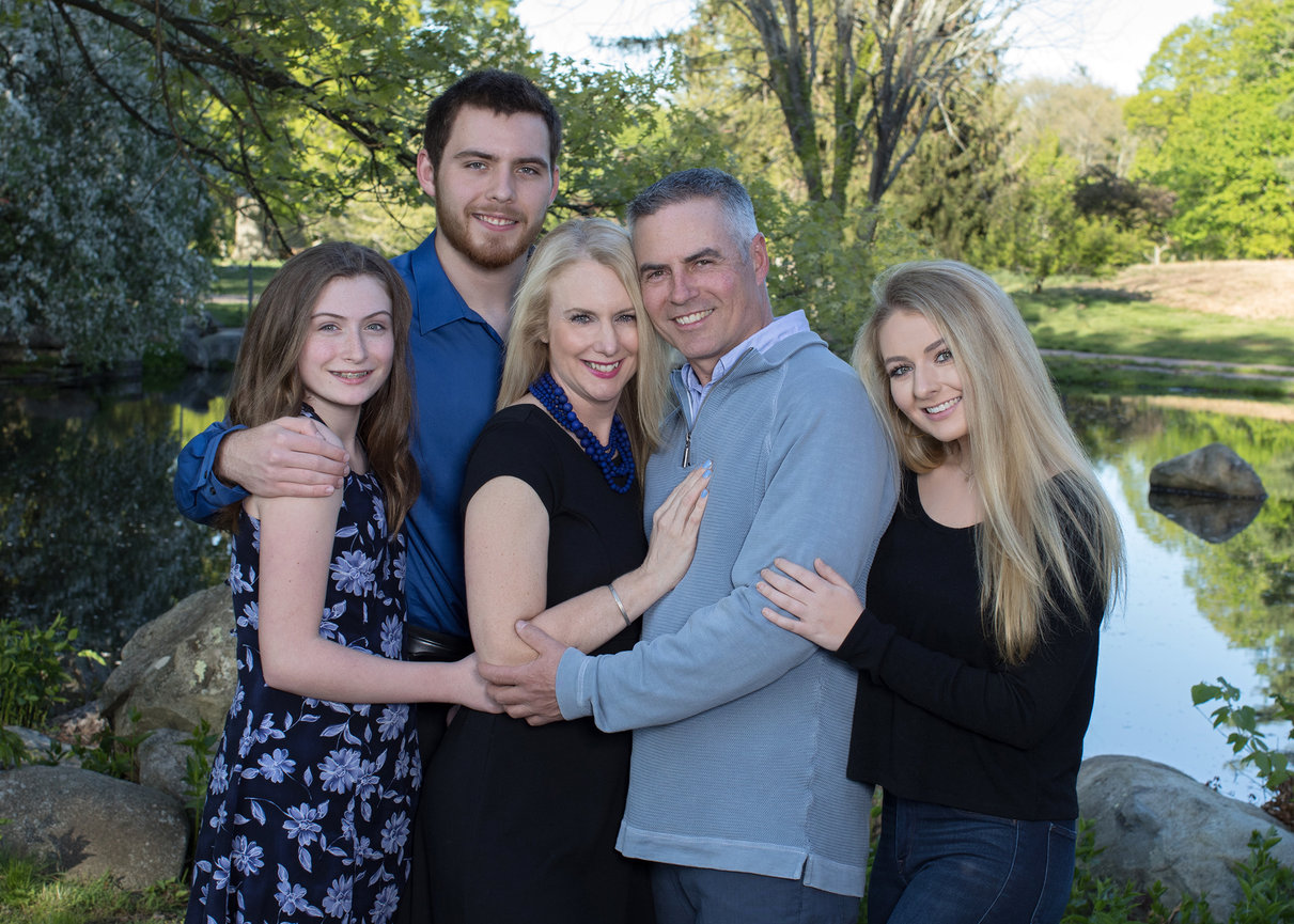 outdoor family portrait with parents and your adult children by pond and rocks westwood ma