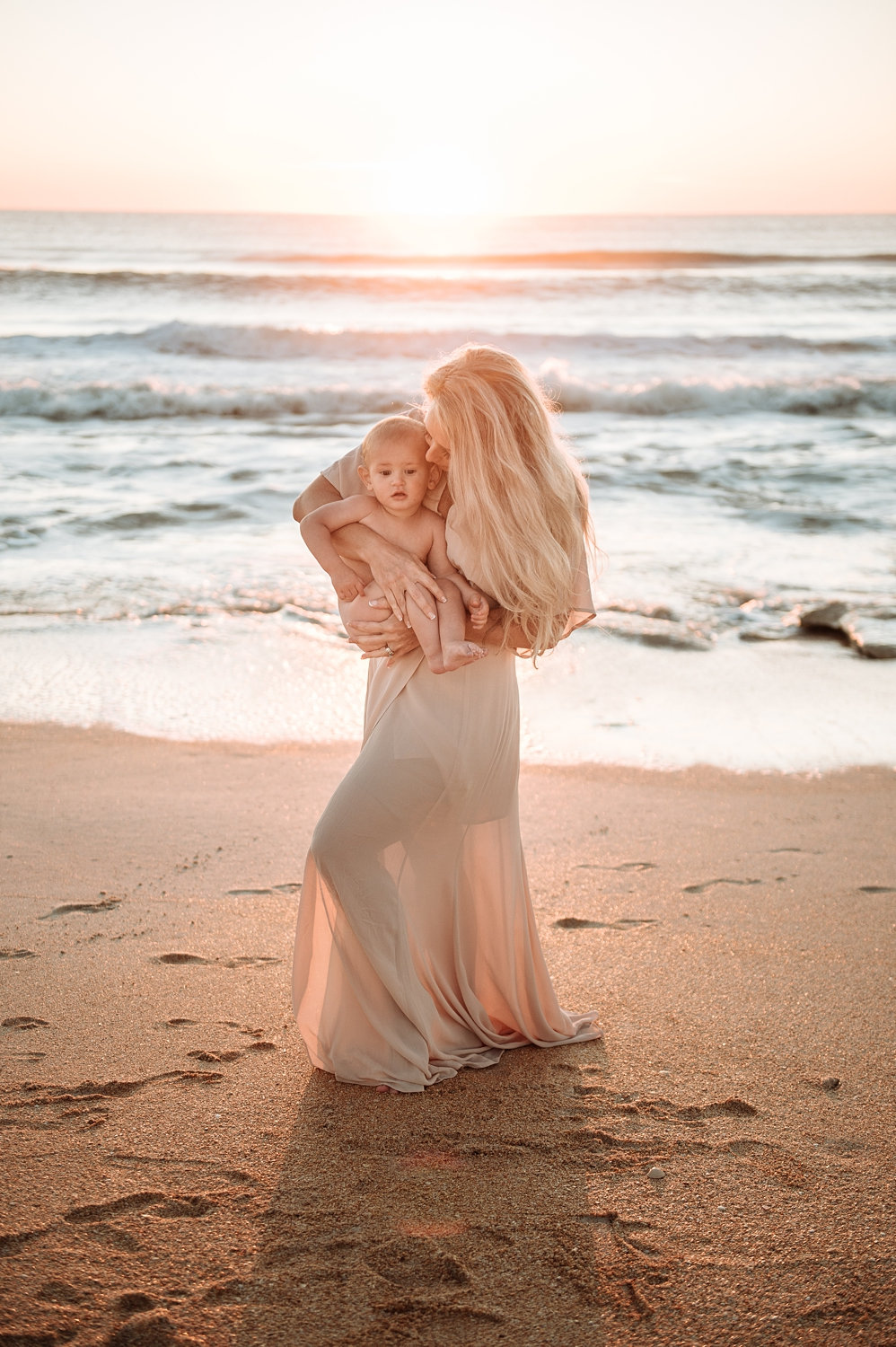 mother cuddling baby boy on the beach at sunset, Ryaphotos, Florida motherhood photographer