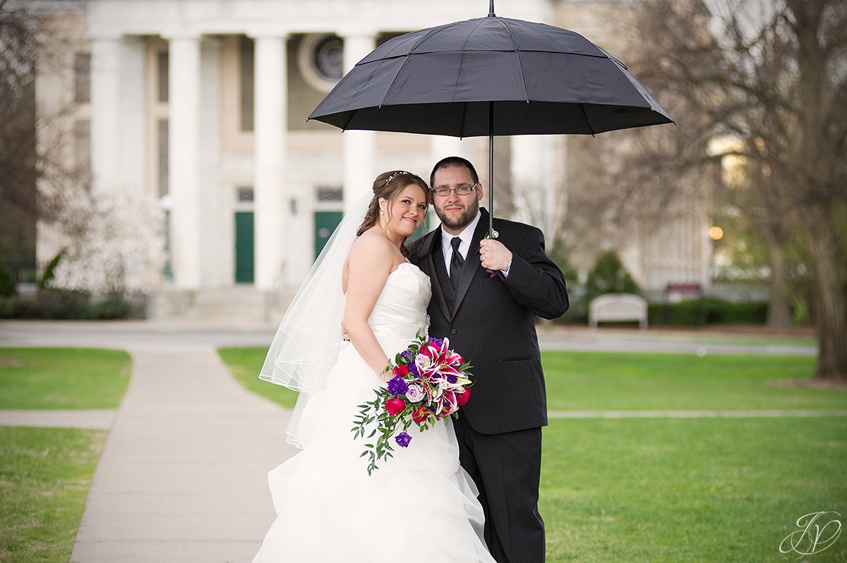 bride and groom beneath an umbrella