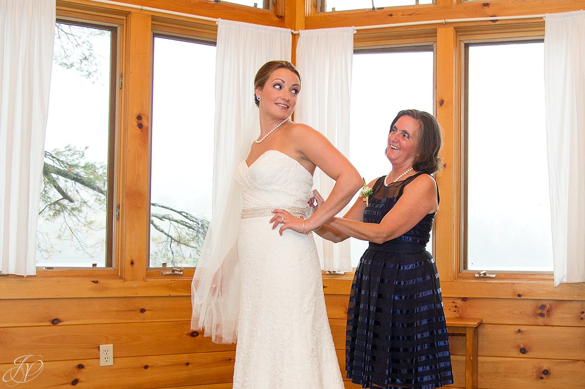 bride getting ready with help from mom