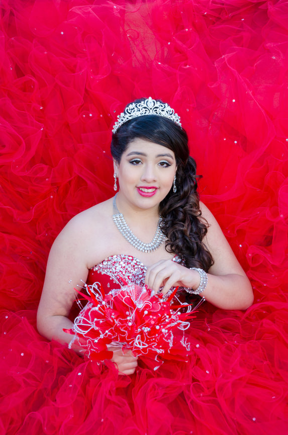 Young woman holding flowers in red gown