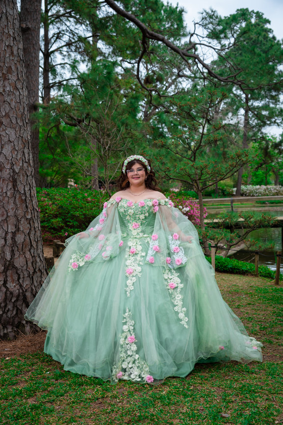 Young woman in embellished green gown outdoors