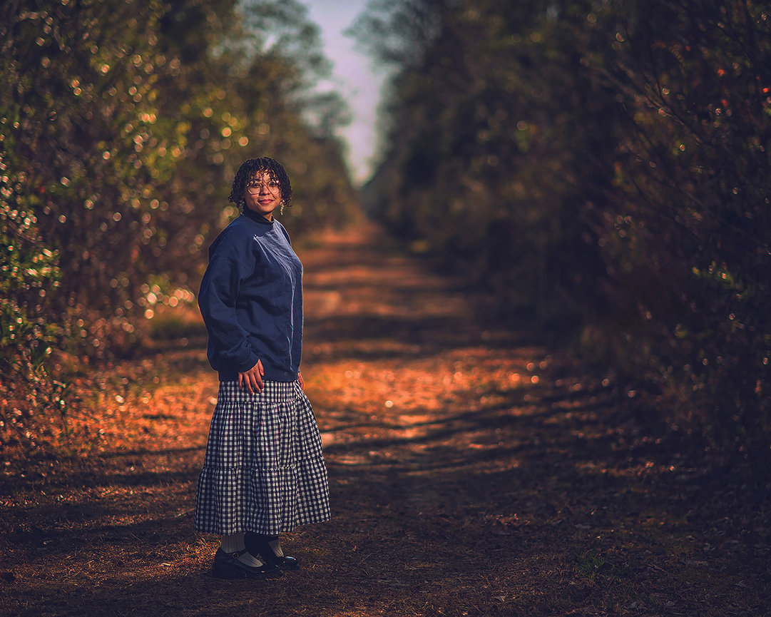Senior portrait on a tree-lined East Texas path in the Spring 77386 corridor by Master Photographer Ty Swartz