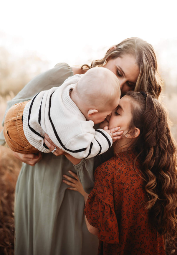 A baby boy kissing his sister on the nose during family photos in Stanhope, New Jersey.