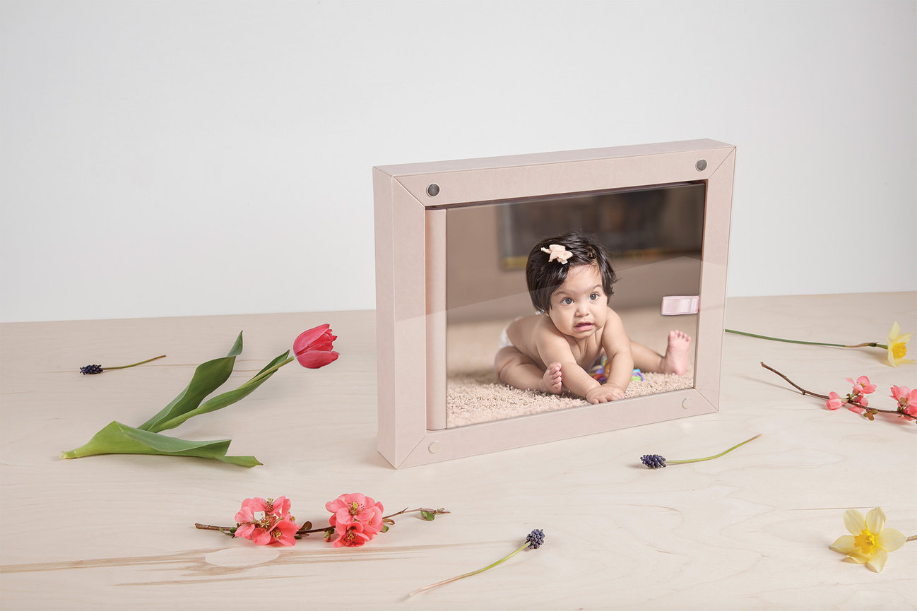 Handcrafted album with acrylic cover featuring a child portrait, presented as a refined and modern collection piece