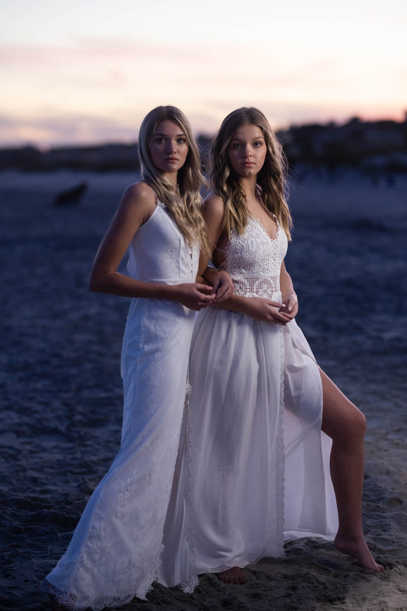 Model Team Members in white gowns on the beach at Sunset