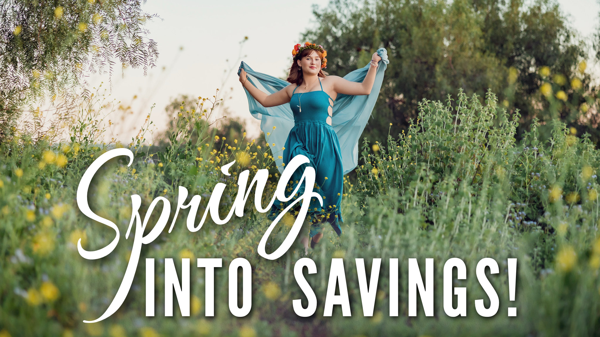 An orange county senior girl dressed in a flowing blue dress running in field of yellow wildflowers.