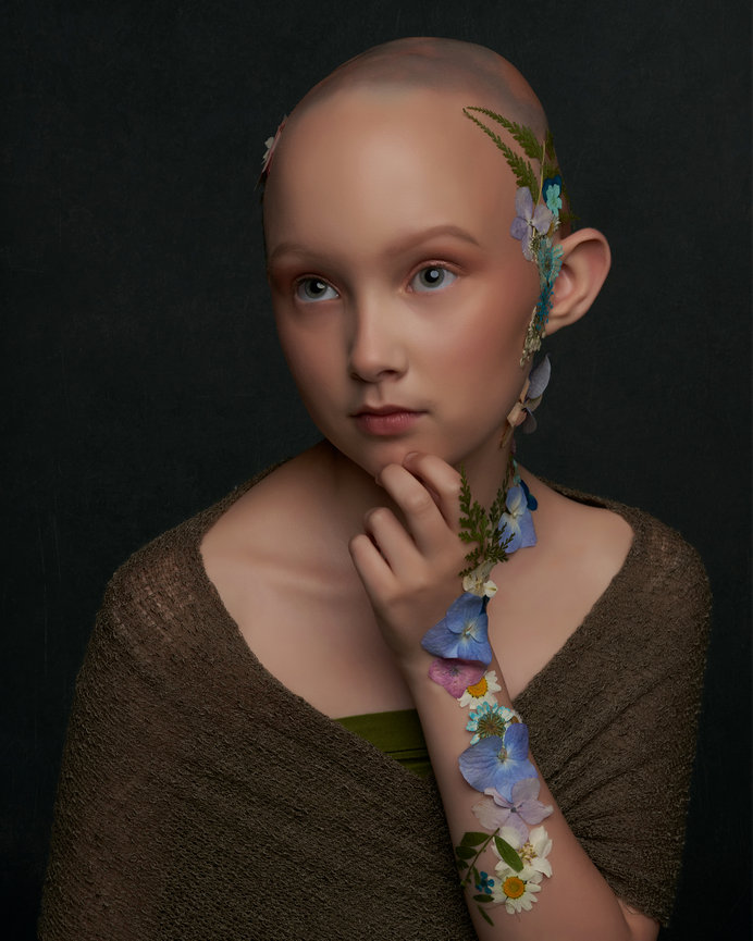 Fine art child portrait featuring delicate floral accents and soft lighting, photographed in studio by a Sherman TX portrait photographer