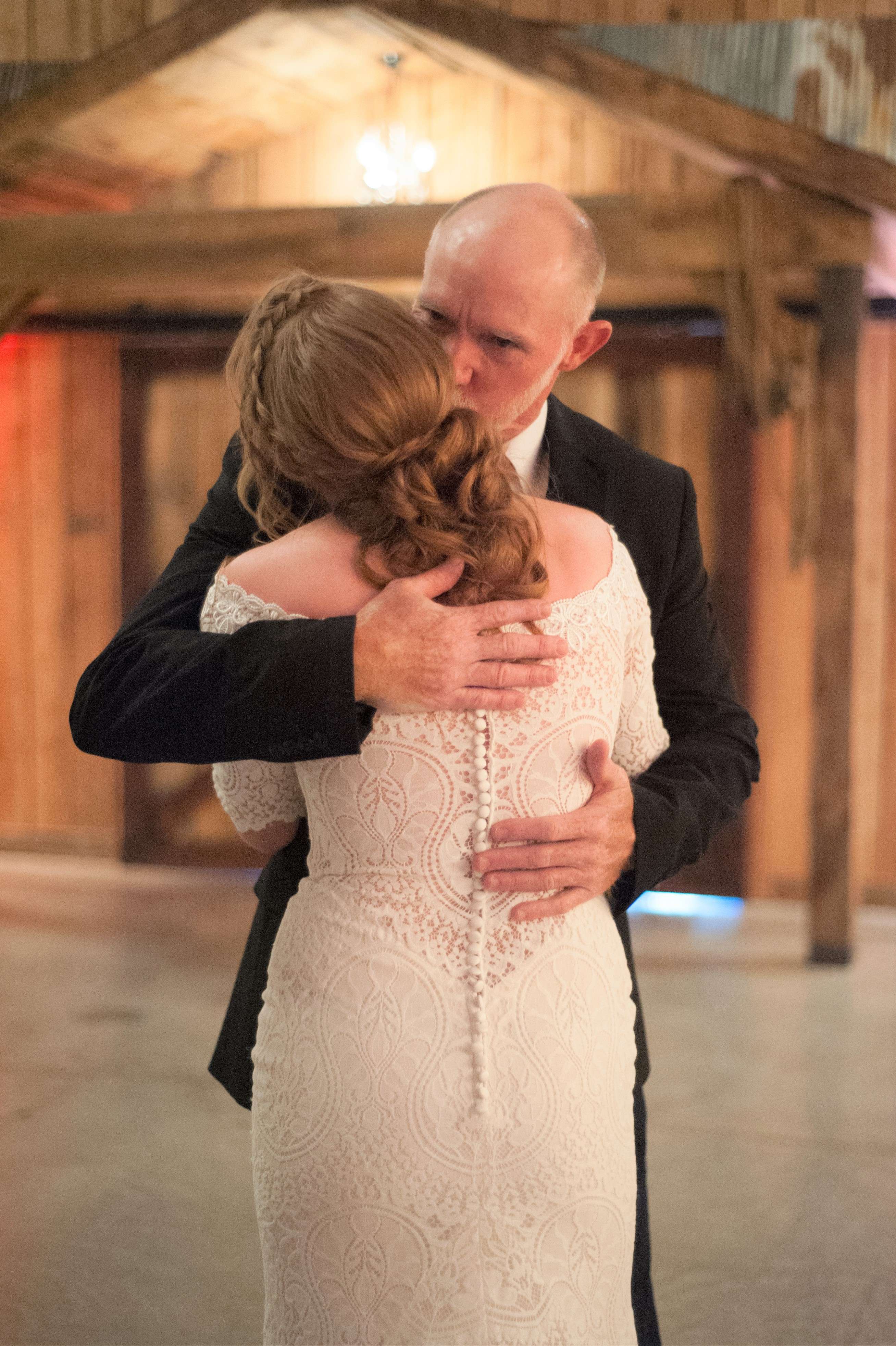 Father kissing his daughter before her wedding ceremony.