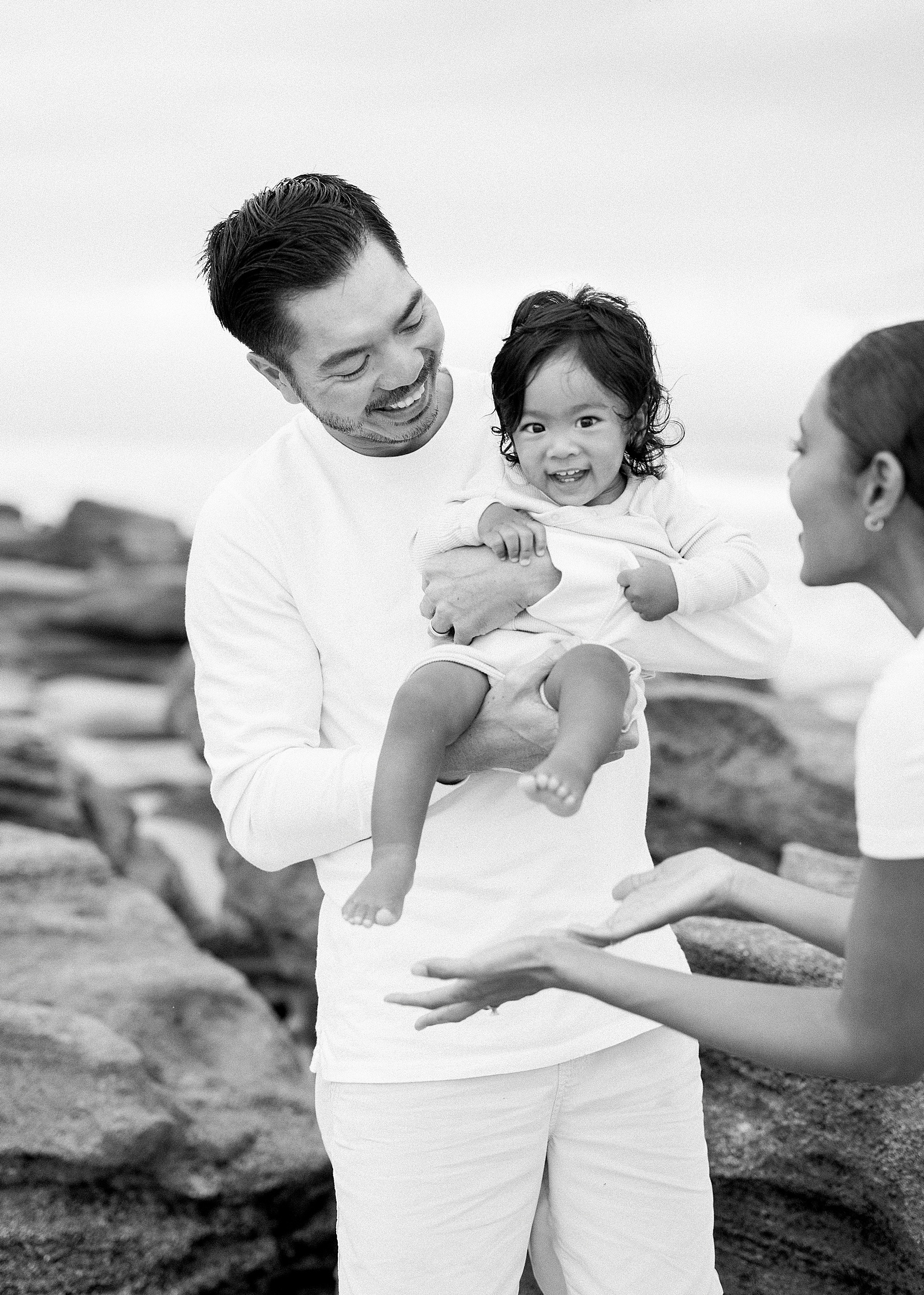 black and white image of family on the beach
