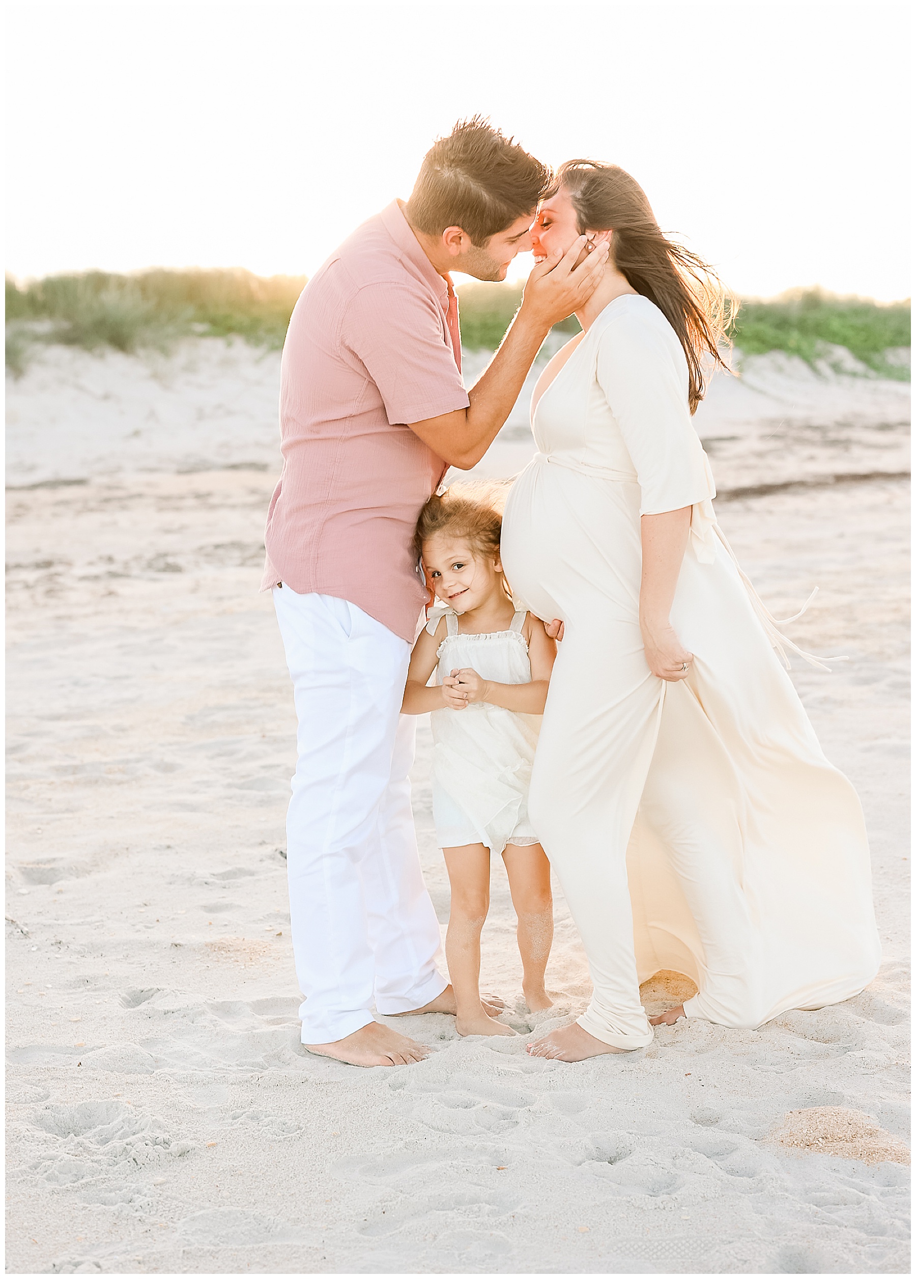 family standing on the sand in saint augustine florida during maternity portraits