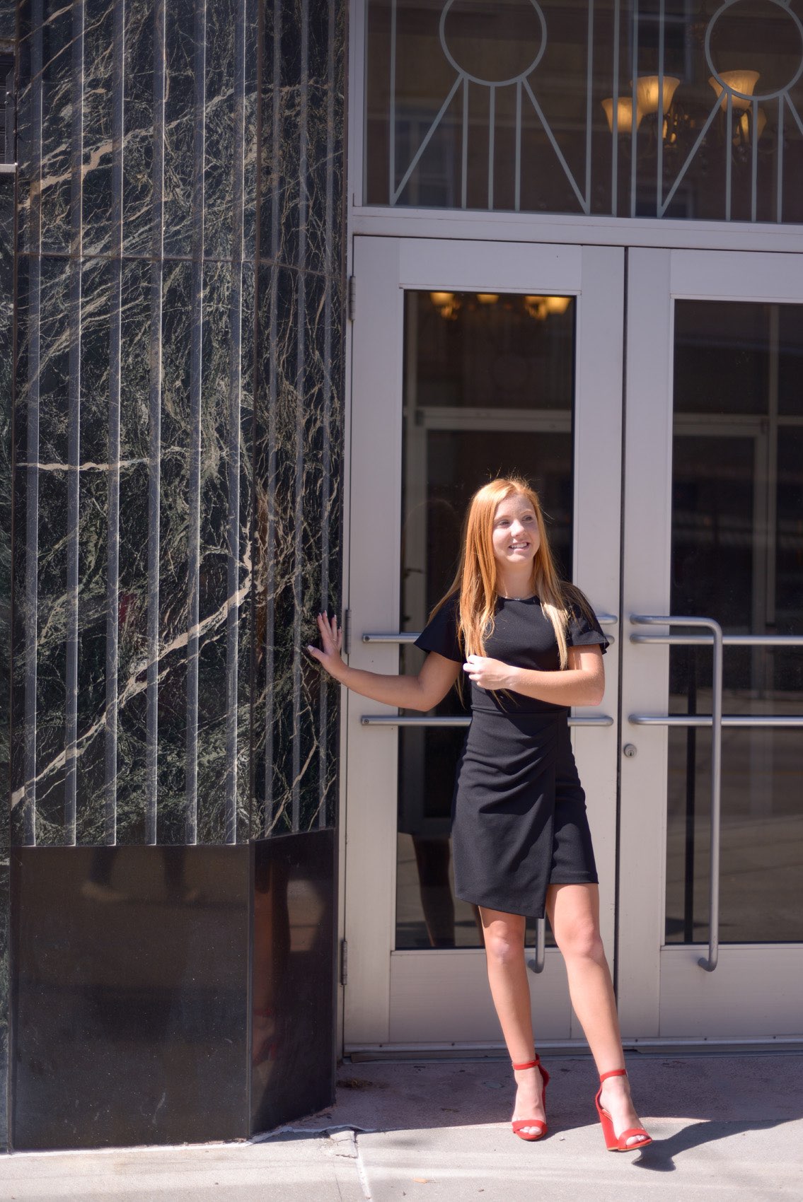 Senior girl in black dress smiling in Springfiled Missouri.