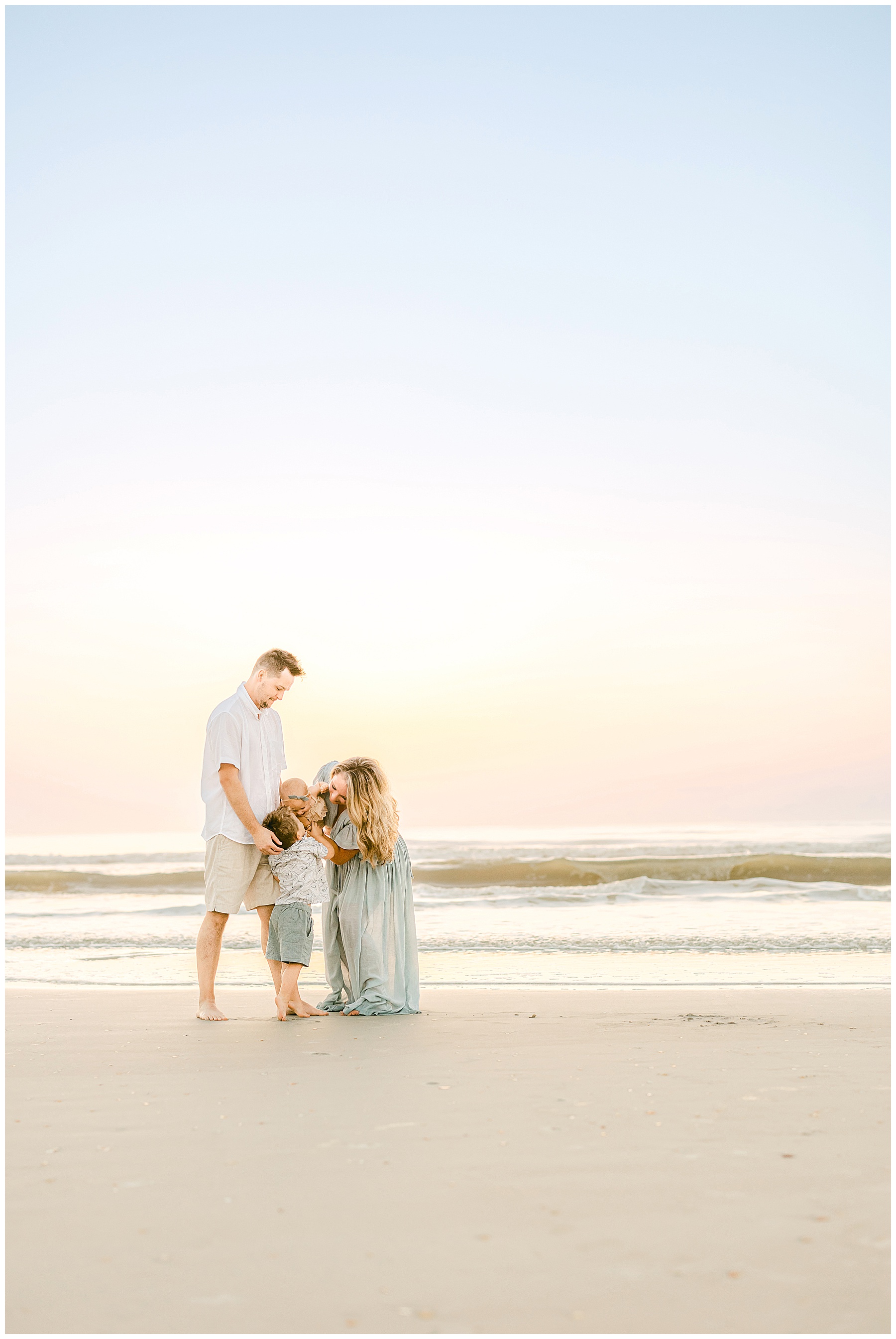 sunrise family beach portraits in saint augustine with pastel skies 