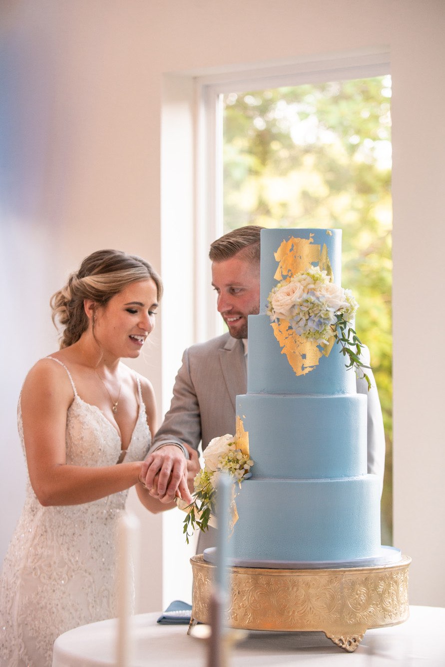 Bride and groom cutting their wedding cake.