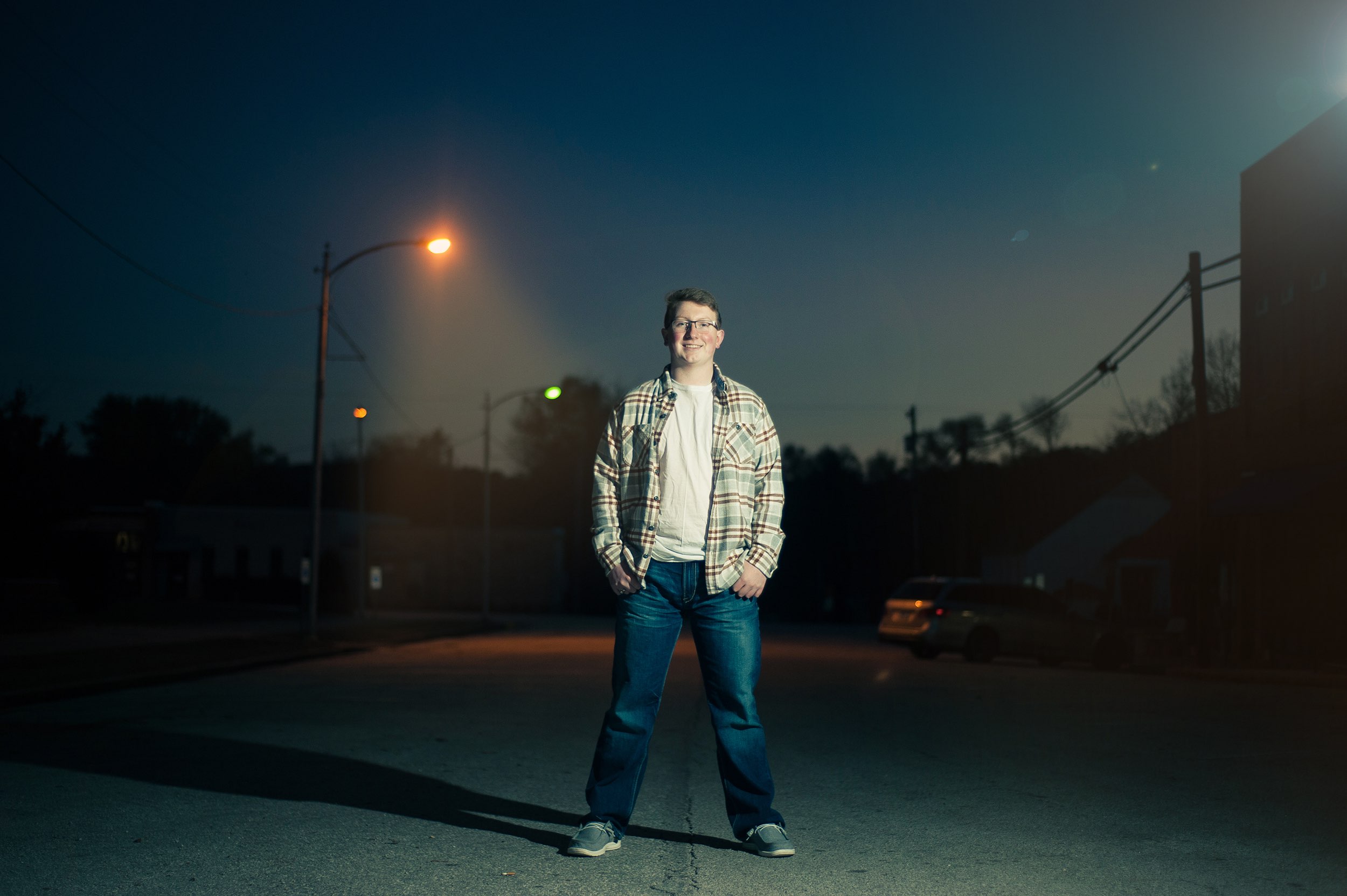 Senior guy in plaid shirt standing in the street in Galena, MO.