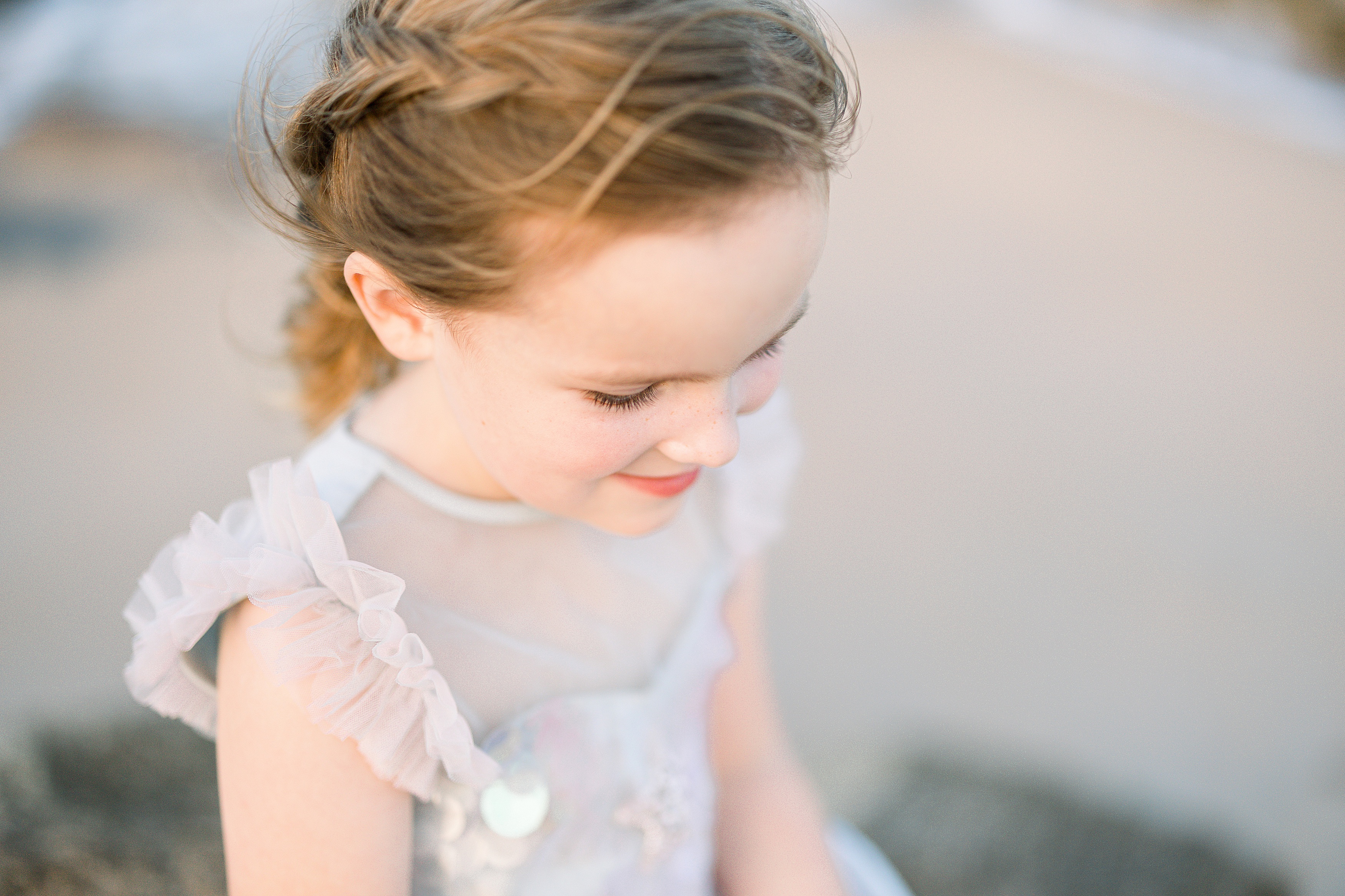 little girl with freckles and a mermaid braid