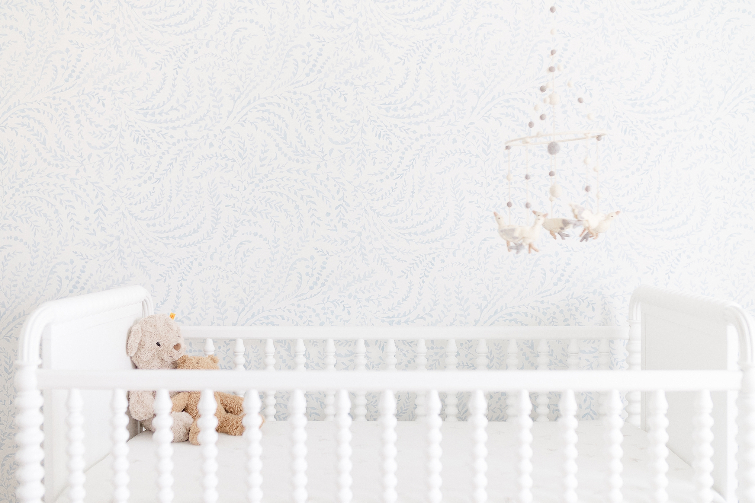 Light and airy newborn photo of white crib.