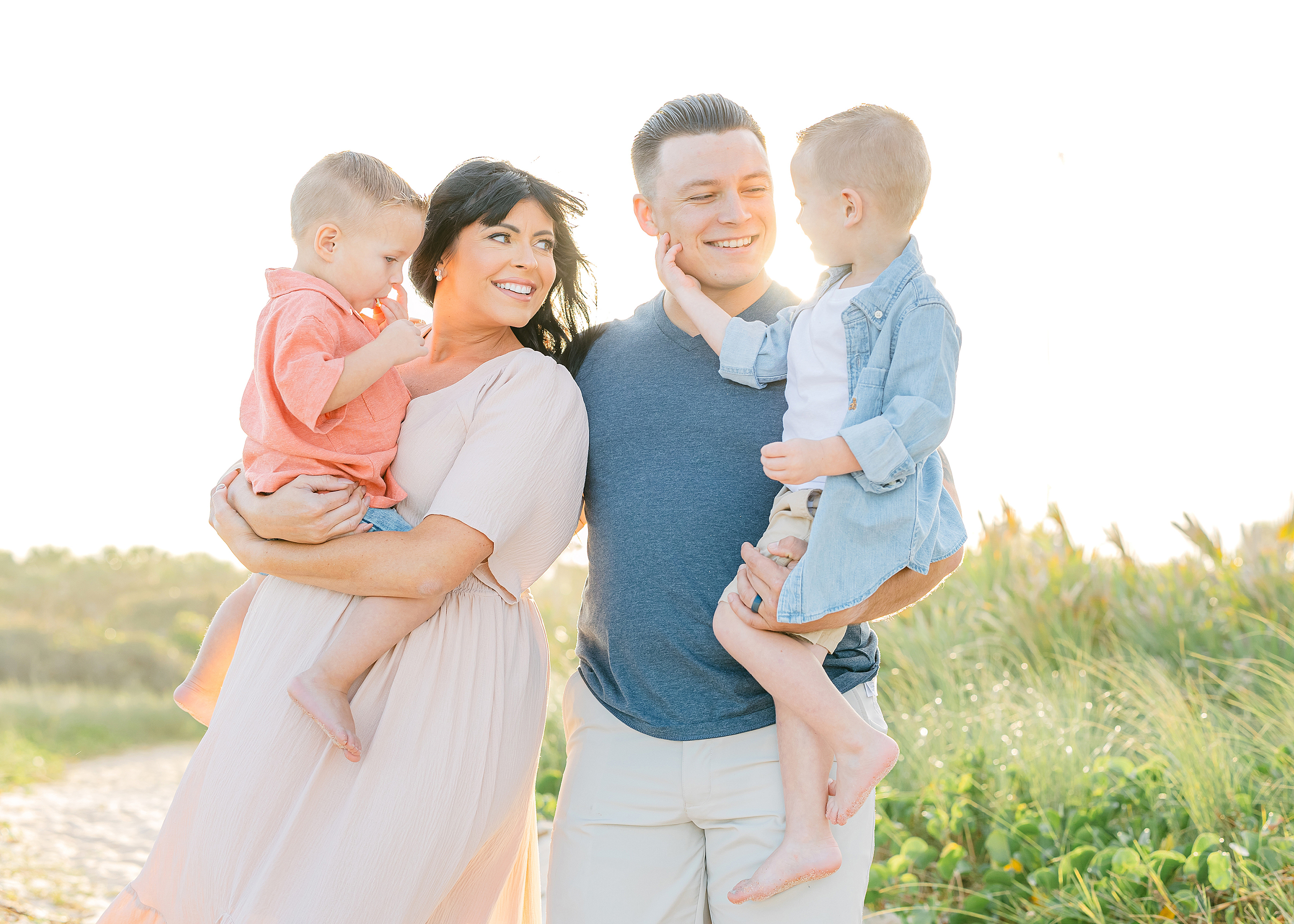 Colorful family beach portrait at sunset.