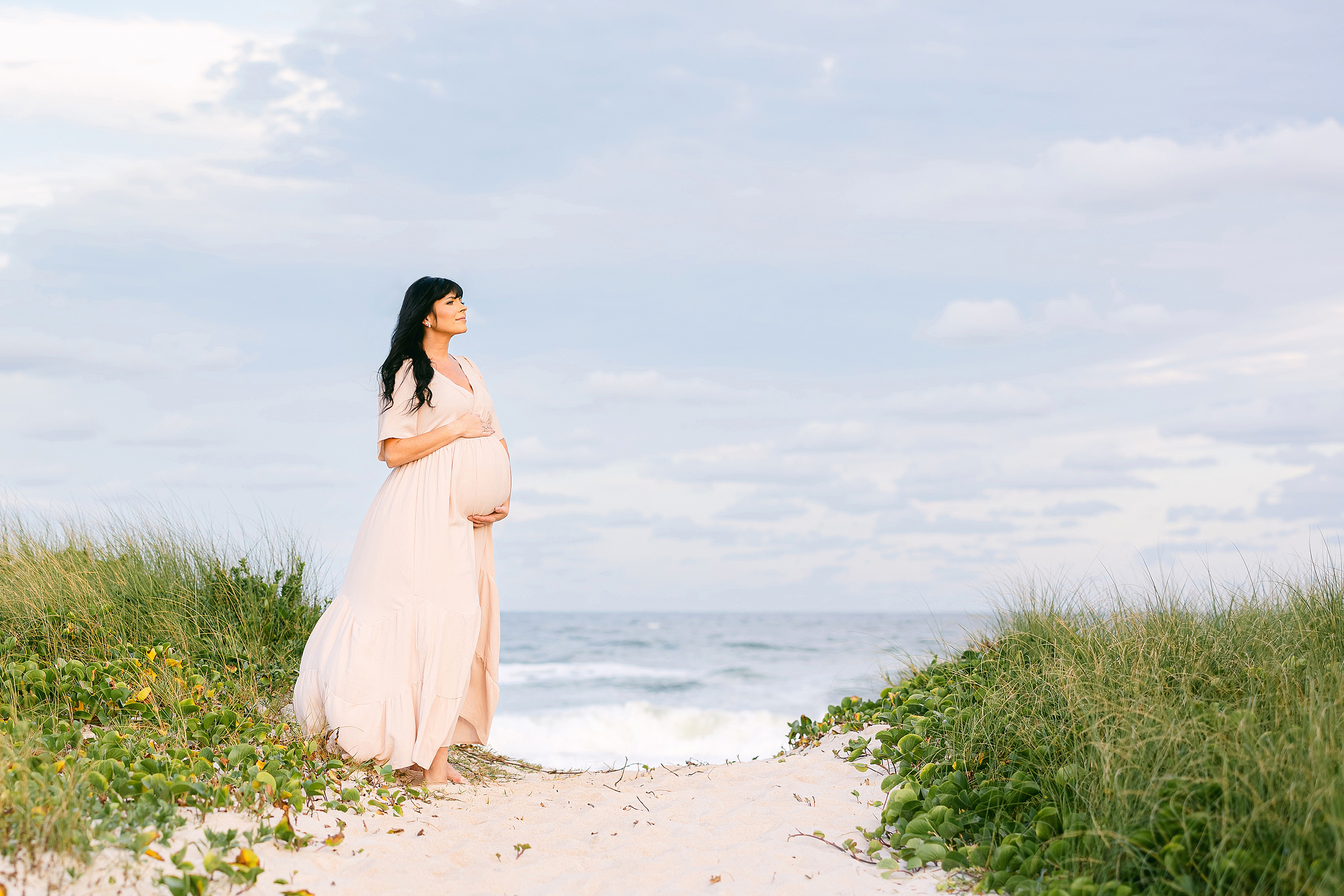 Colorful maternity portrait at sunset in St. Augustine Beach, Florida.