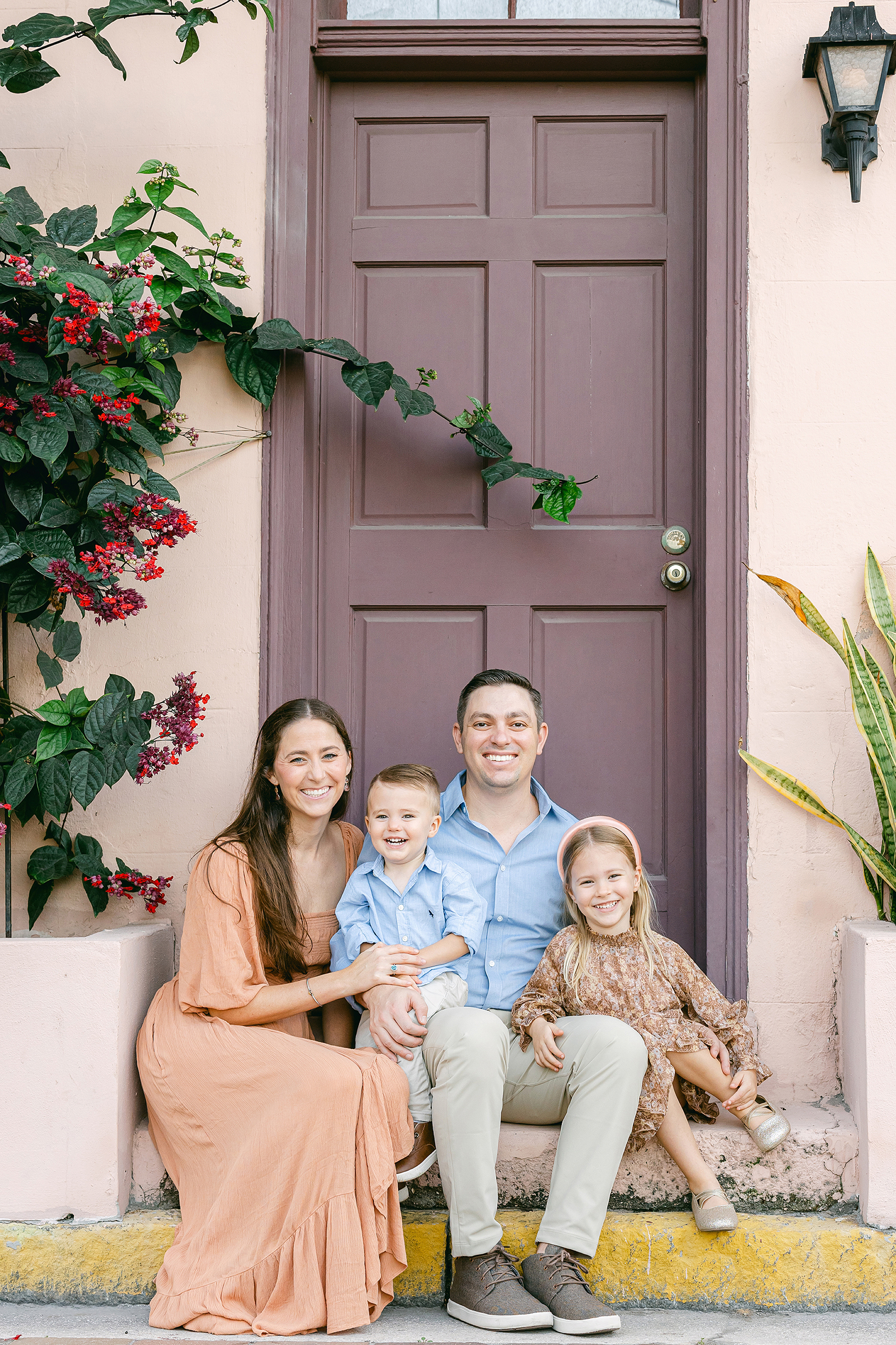 Lifestyle family portrait on the steps of Aviles Street in downtown St. Augustine.