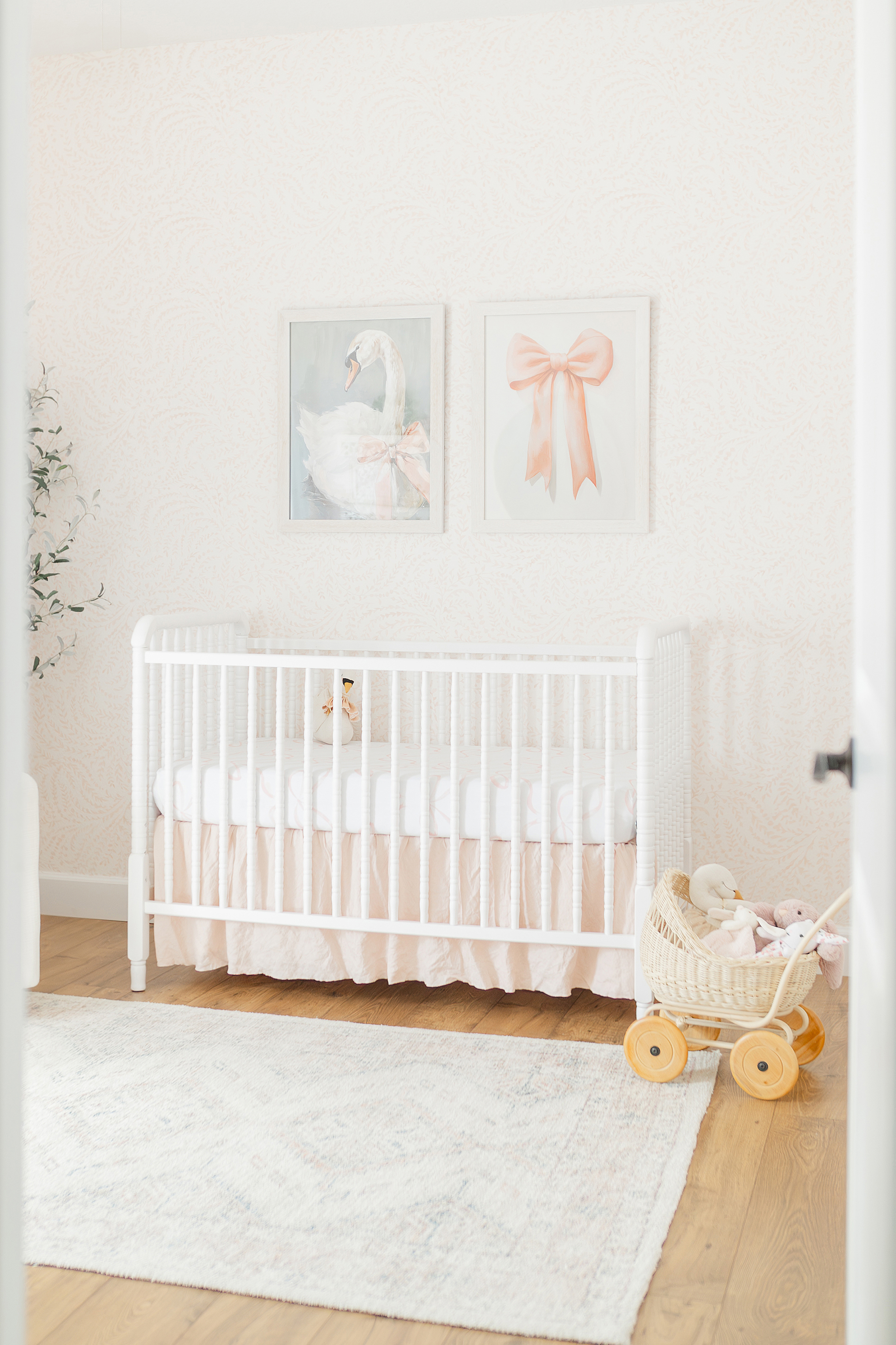 An in home newborn session of a baby girl's pink and white nursery.