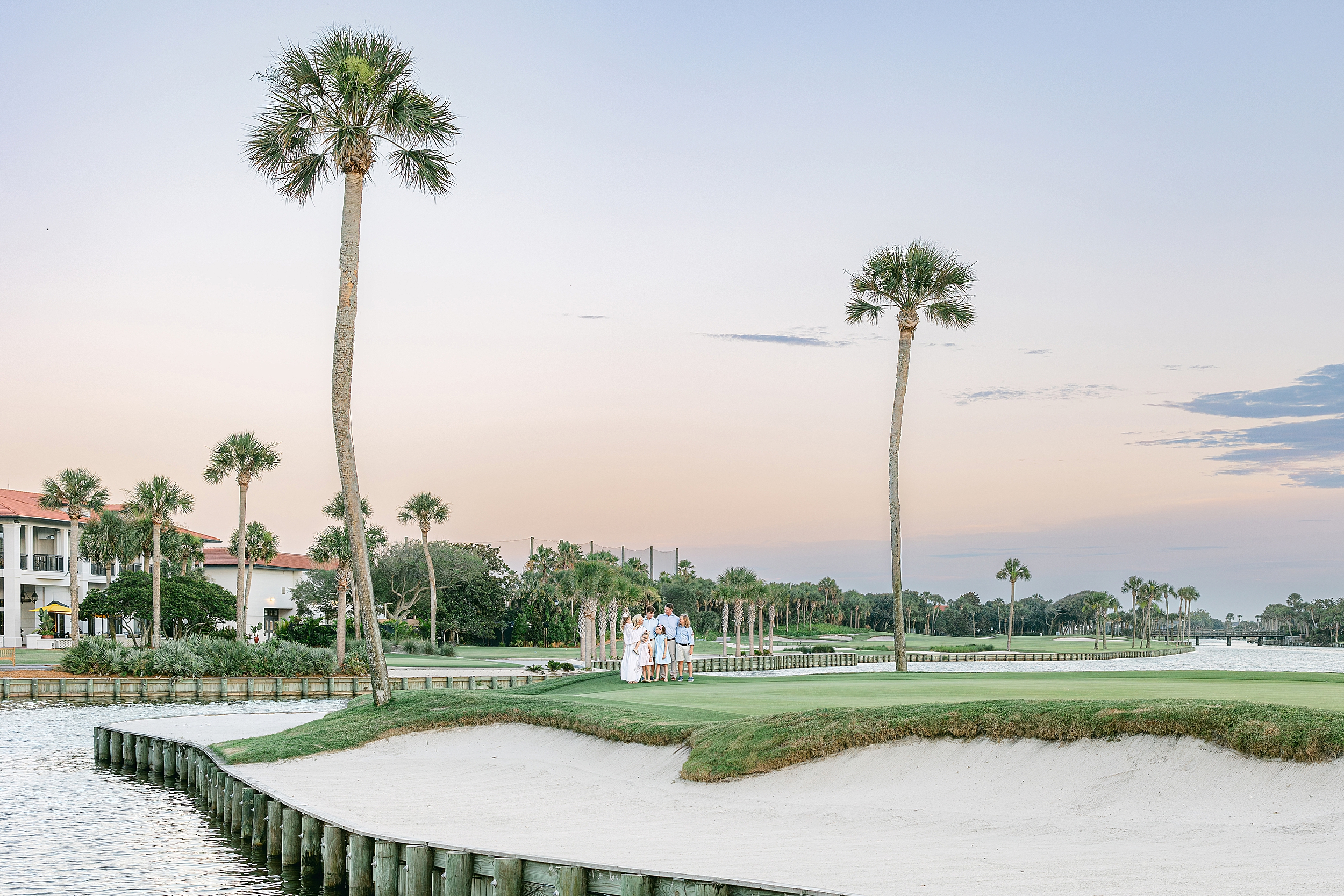 A pastel family portrait at sunset on the golf course at Ponte Vedra Beach, Florida