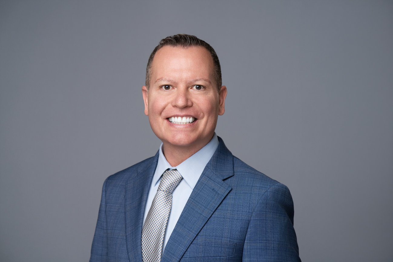 Executive-style professional headshot with studio lighting used for LinkedIn and corporate branding