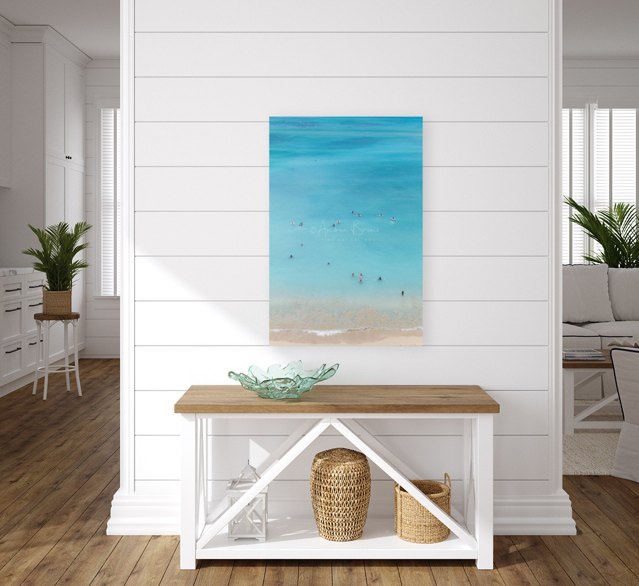 A turquoise beach Wall Art displayed in a wonderful white costal themed home with natural hardwood floor