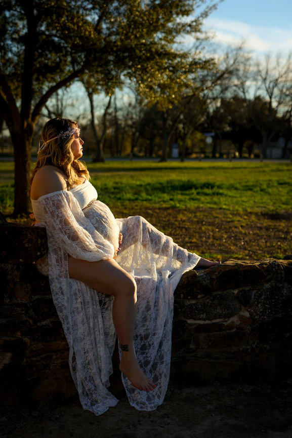 Maternity session in San Antonio, TX wearing a white lace dress.