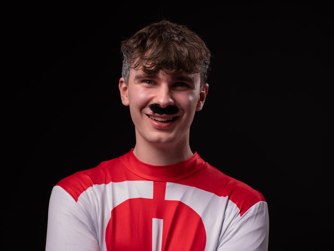 Athlete flexing under low-key lighting, photographed by a London-based commercial photographer