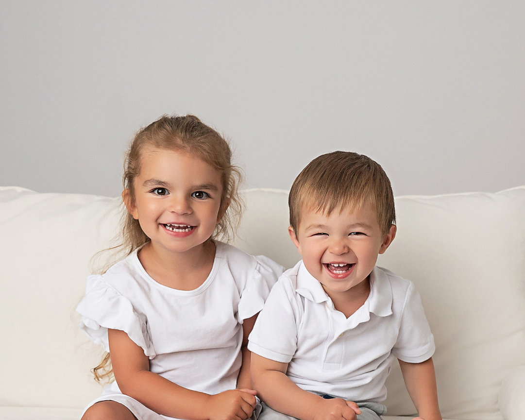 Classic portrait of brother and sister in light-filled NJ studio
