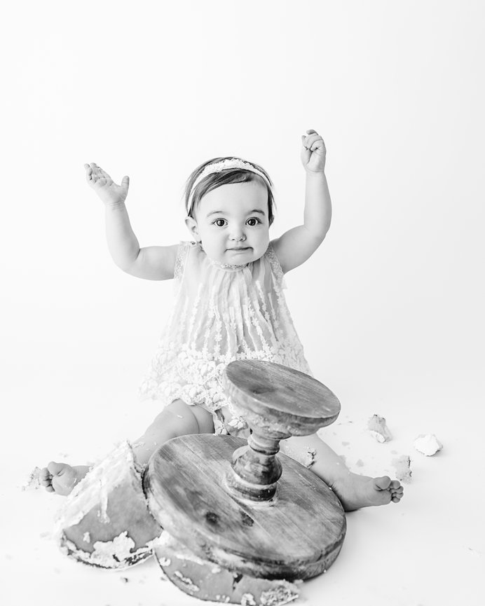 Timeless black and white photo of baby finished eating cake during East Brunswick photoshoot