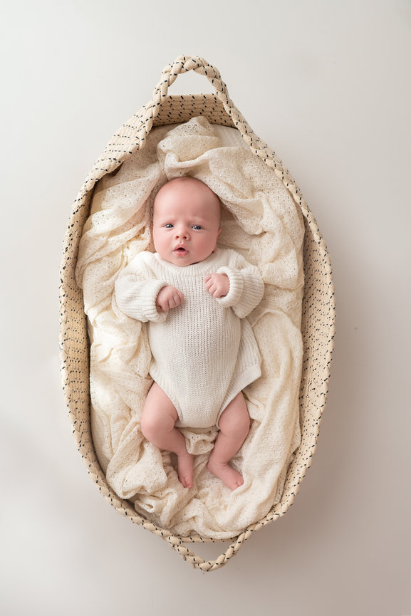 Awake newborn photo with natural window light in a cozy Manasquan studio