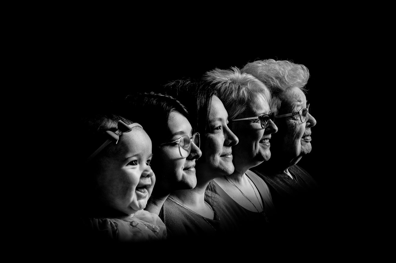 Five generations of women from baby to elderly, side profile, black and white.