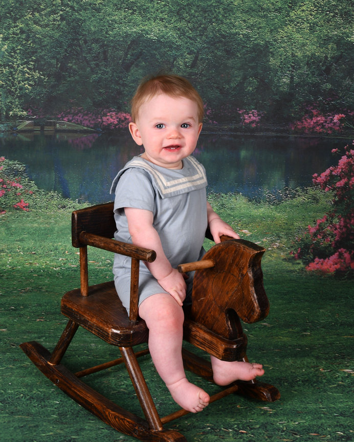 Smiling child on a rocking horse