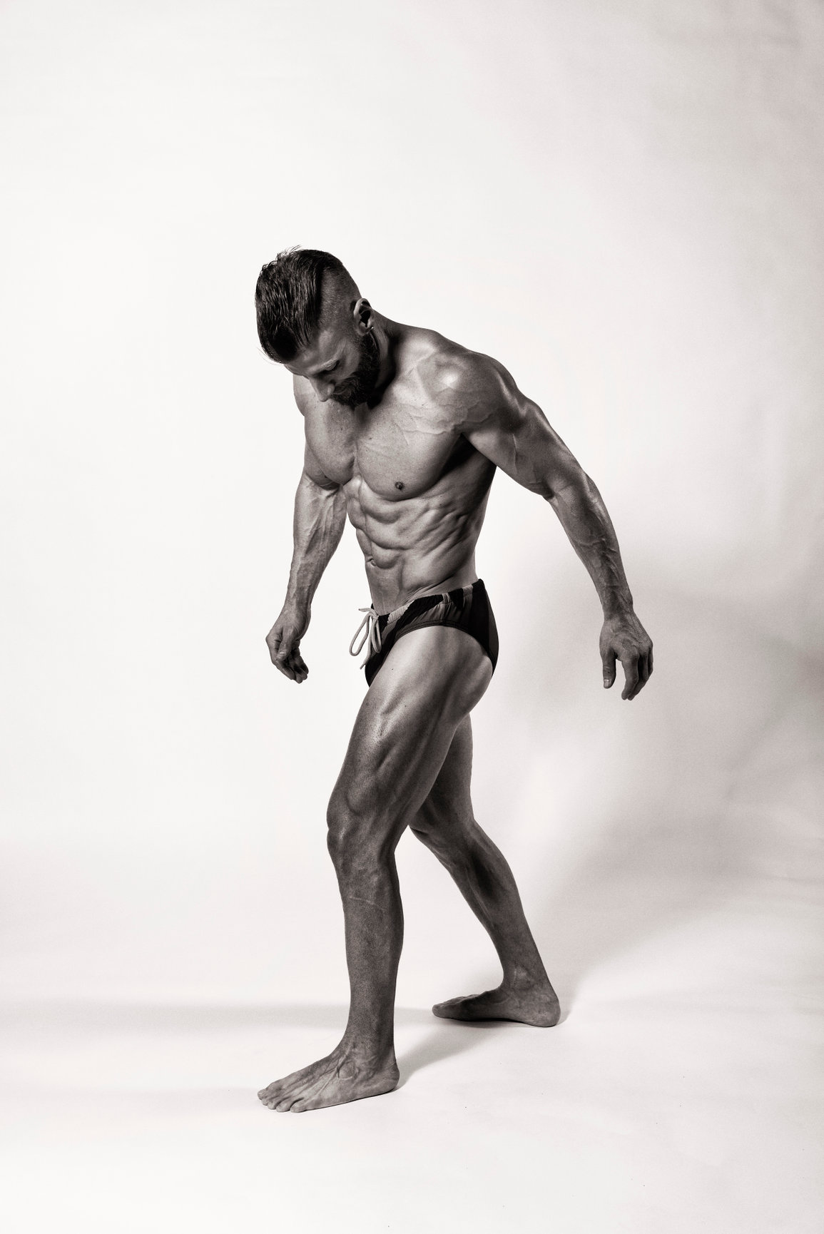 black and white photo of a very fit man