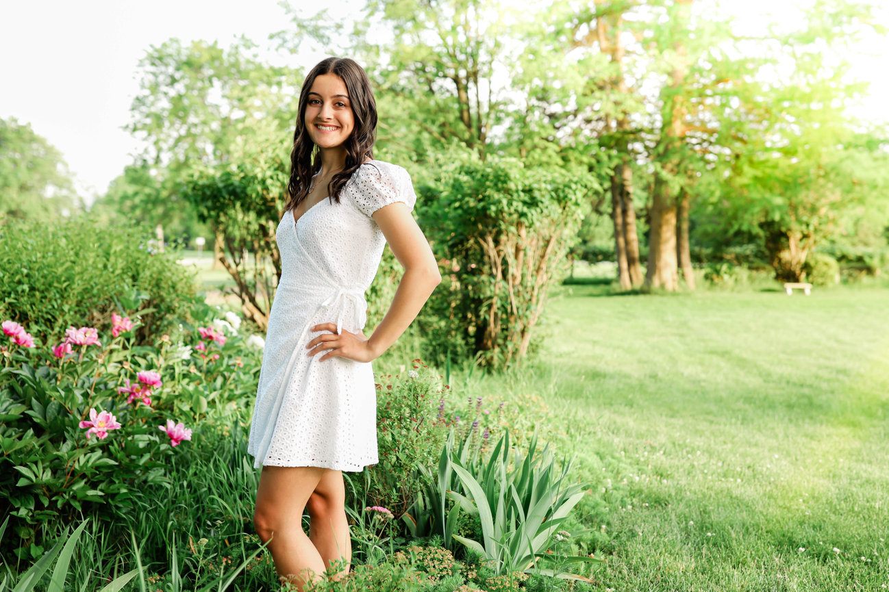 High school senior girl smiling and posing outdoors during a Farmington senior photography session