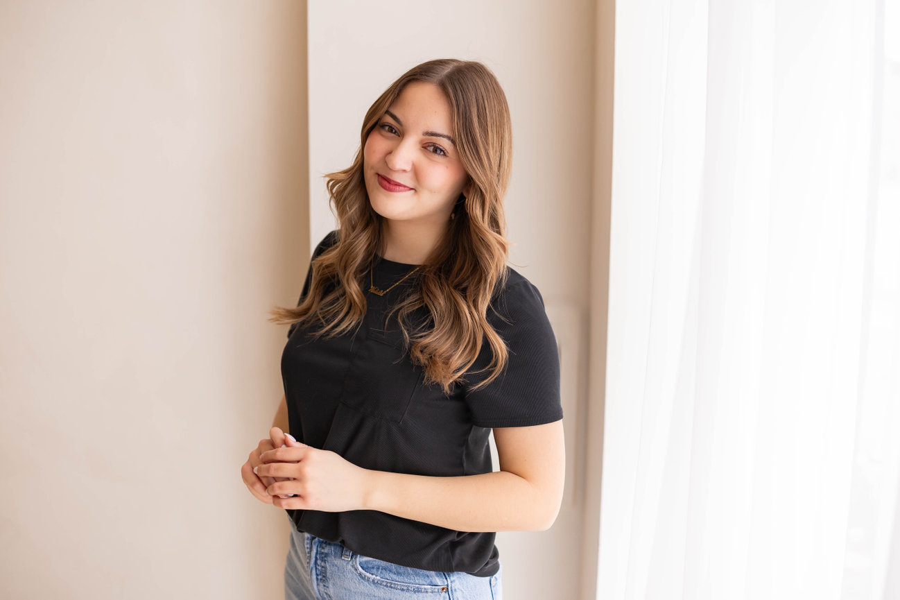 Modern business headshot of woman with long hair and medical coat with clean background