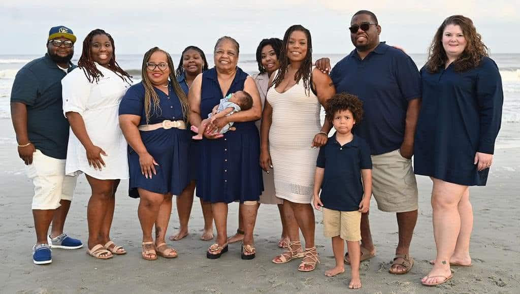 Large family posing together on the beach