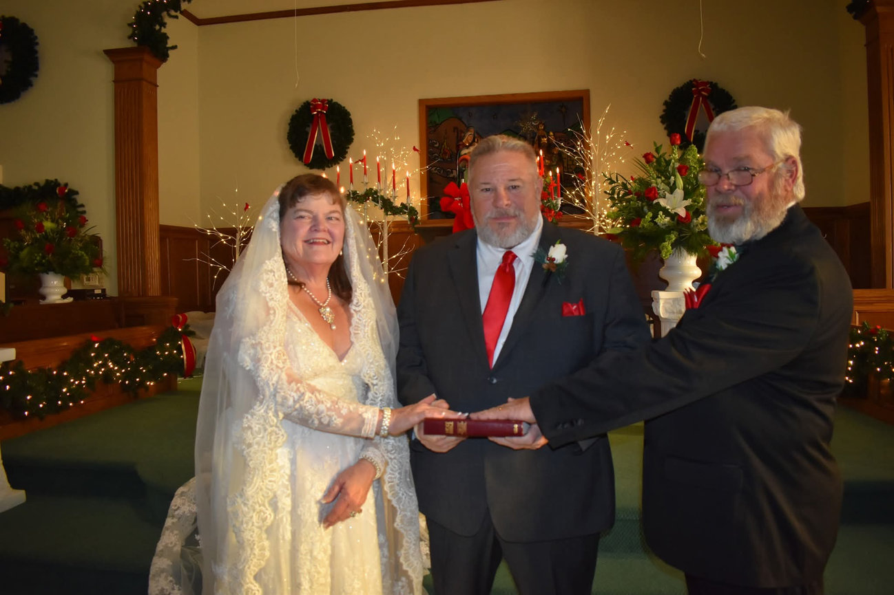Bride, groom, and officiant during a wedding ceremony