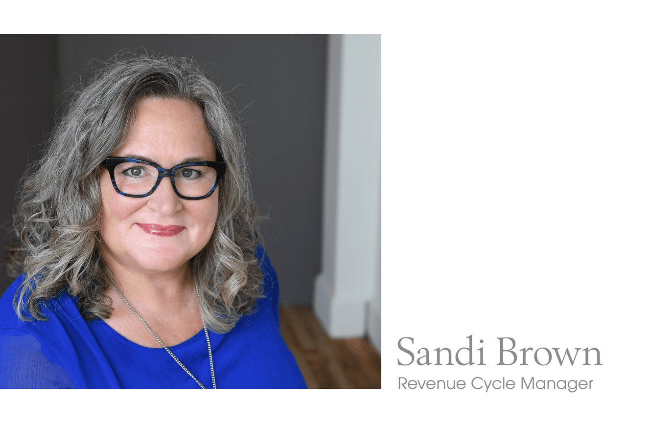 A bright spirited woman wearing blue eyeglasses and blouse.