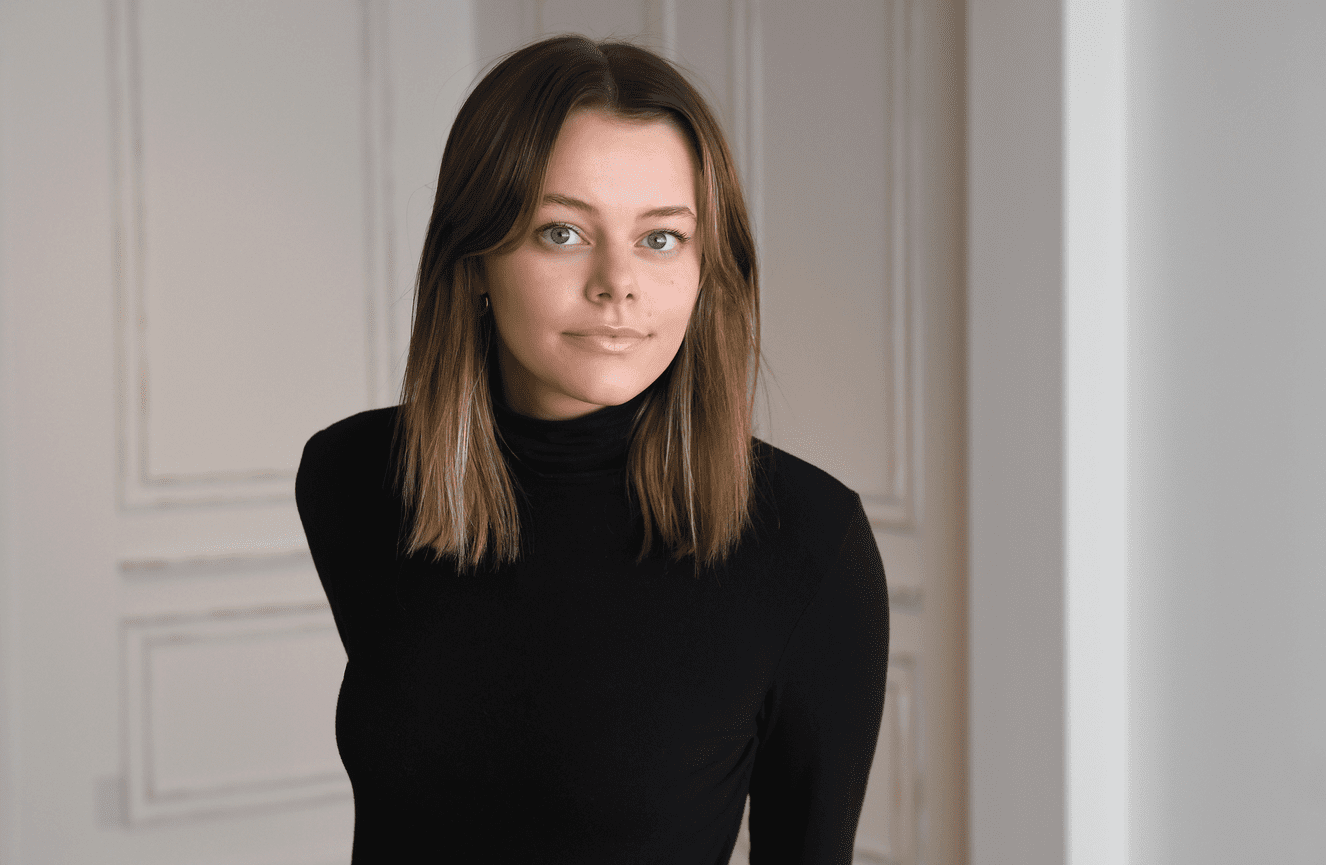 A girl in a black turtle neck looking timeless in her senior photo.
