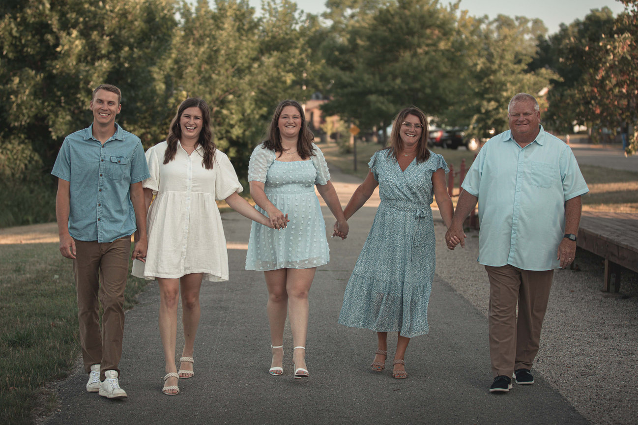 Family walking together hand in hand in a park